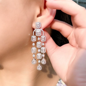 Elegant silver tassel earrings with geometric zircon drops shown on model for party style