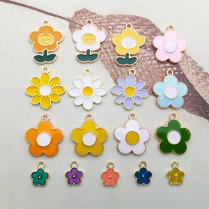 Flat lay of colorful enamel flower charms for DIY jewelry in daisy and sunflower designs