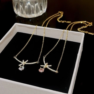 Luxurious bow water drop necklaces with white and pink crystal pendants in gold finish