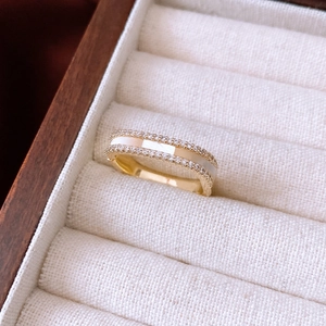Detailed view of 14K gold plated ring with white inlay and sparkling zircon stones
