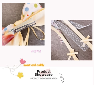 Detail of polka dot bow hair clip with lace ribbons and metal duckbill clip back