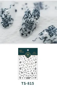 Macro detail of TS-815 black lace flower nail stickers with matte finish and pearl accents