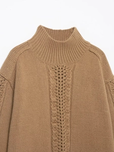 Dettaglio del maglione in maglia color cammello con collo a lupetto e trama a traforo