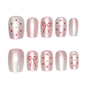 Pink cat eye press-on nails set with red bow patterns and polka dots design