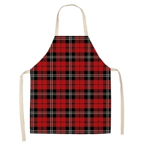 Detailed view of red and black plaid apron with beige neck strap and high-quality linen texture