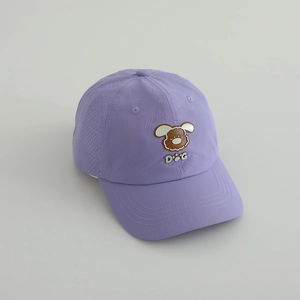 Detail of purple quick-dry cap showing side ventilation holes and cute dog patch