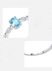 Detail of s925 silver ring featuring blue crystal and S925 hallmark on the inner band