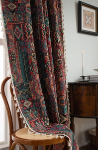 Detailed view of woven geometric jacquard fabric with tassels in a cozy home setting