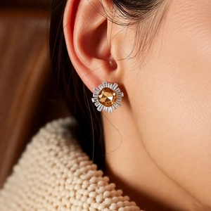 Detailed view of champagne zircon sunflower stud earring on model for elegant vintage style