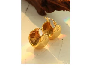 Detailed macro view of 18K gold plated C-shaped hoop earrings with polished finish