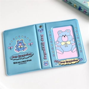 Close-up of blue PVC photo card album featuring cute bear patterns and sweet dream text