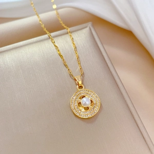 Detail of round pearl necklace with gold clover frame and micro-pave zircons on silk