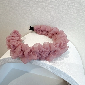 Detail of pink pleated tulle headband showing delicate ruffled organza fabric texture