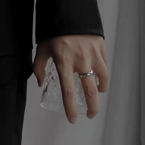Polished silver Mobius ring in minimalist twisted design worn by model on finger