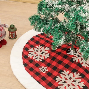 Red and black plaid Christmas tree skirt with beige snowflakes and white faux fur trim