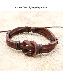 Macro detail of multilayer brown leather bracelet with center knot on stone background