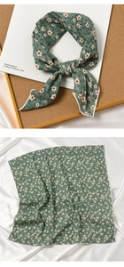 Detail of dark green floral cotton-linen scarf with delicate stitching and artistic setup