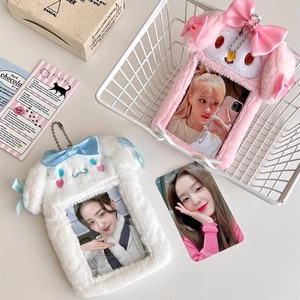 Close-up of pink and white plush card holders with soft faux fur texture and bead chains