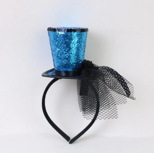 Close-up of a blue sequined mini witch hat headband with lace veil for Halloween party