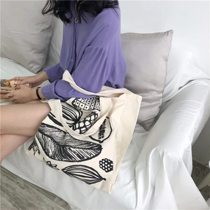 Detail of leaf print on thick canvas tote bag showing large capacity and texture