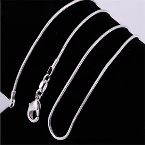 Classic 1mm silver plated snake bone chain necklace with lobster clasp on black velvet