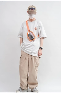 Clear orange jelly PVC crossbody chest bag shown on model for size and style reference