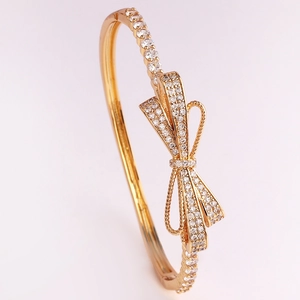 Luxury gold plated bow bangle featuring sparkling pave white cubic zirconia for women