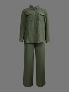 Detail of olive green pleated fabric on casual long sleeve shirt and wide-leg trousers set