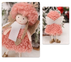 Detail of pink plush angel ornament with fuzzy wings and golden heart for Christmas decor