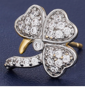 Macro view of clover stud earrings with silver and gold finish and zircon stones