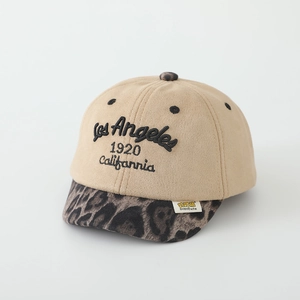 Close-up of beige suede kids baseball cap featuring leopard print brim and embroidery