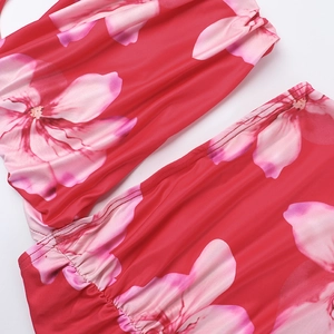 Macro shot of red floral fabric showing high-quality stitching and stretchy smooth texture