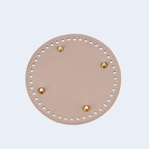 Macro view of 15cm round PU leather bag base with golden feet for DIY bucket bags