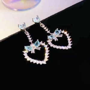 Elegant bowknot heart drop earrings with sparkling light blue gemstones and silver tassels