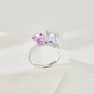 Macro shot of S925 silver ring featuring pink pear and clear emerald cut stones