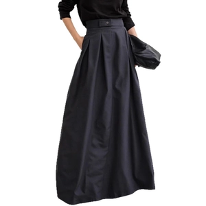 Close-up of high-waist pleated A-line skirt with belt loops and subtle fabric sheen