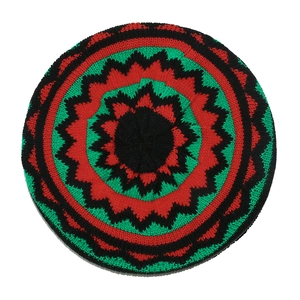 Top view of handmade crochet Rasta beret featuring red green and black knit patterns