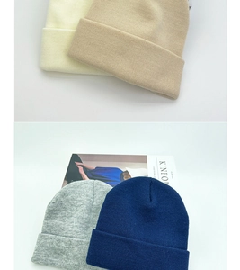 Detail view of double-layer knit beanies in cream, beige, grey, and navy blue