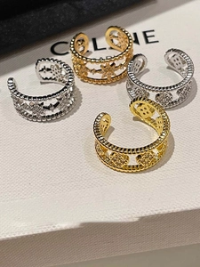 Set of gold and silver ear cuffs with star and clover patterns on a white display box