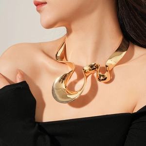 Close-up of a chunky irregular geometric gold collar necklace on a model in black