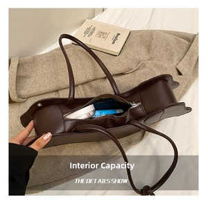 Detailed interior view of a wavy edge brown crossbody bag with blue lining