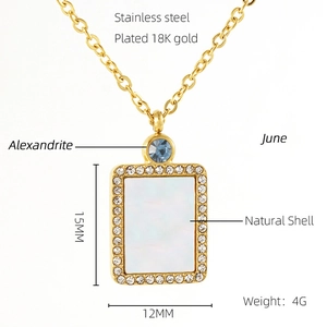 Detail of 18K gold plated necklace with June alexandrite stone and natural shell pendant