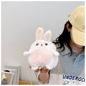 Detail of cute white plush rabbit crossbody bag with golden chain and pink accents