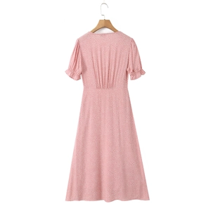 Detail of pink polka dot dress with ruffled bubble sleeves and elastic waist on hanger