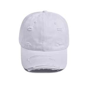 Macro detail of white distressed cotton baseball cap with torn edges and vintage holes