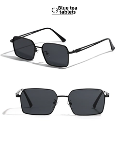 Detail view of square metal sunglasses with dark blue tea lenses and slim black frames