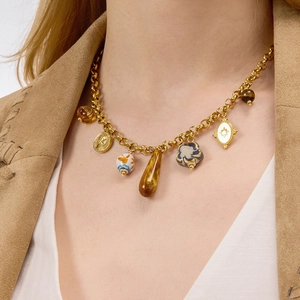 Bohemian gold stainless steel necklace with resin charms and ceramic beads on a model