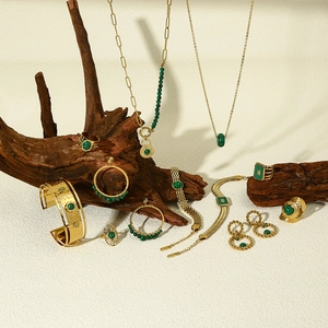 Vintage 18k gold plated jewelry set with green malachite on driftwood display
