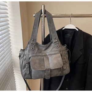 Macro view of vintage gray tote bag with buckle pocket and textured PU leather finish