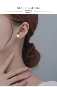 Detailed view of an S999 silver stud featuring a 6-8mm round white pearl on an earlobe